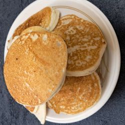American style pancakes - cooked and stacked on a plate.