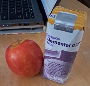 An apple with a 200ml carton of Elemental 028, the prescription nutrition that I use when away from home.