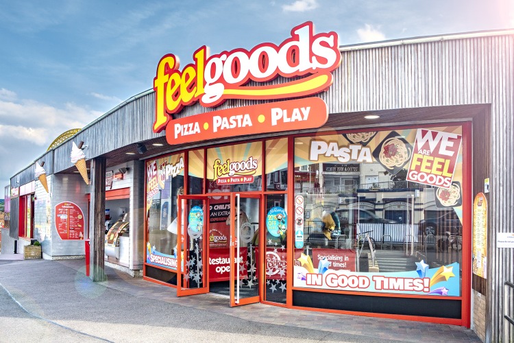 The glass frontage, eith bold red framing, of Feelgoods Diner, Adventure Island. Pizza, Pasta, Play.